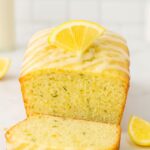 Luscious Lemon Zucchini Bread topped with a drizzle of lemon glaze and a slice of fresh lemon.