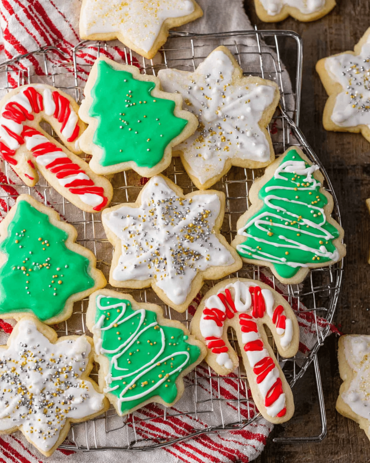 Assorted Christmas sugar cookies shaped like trees, snowflakes, and candy canes, decorated with colorful icing and sprinkles.
